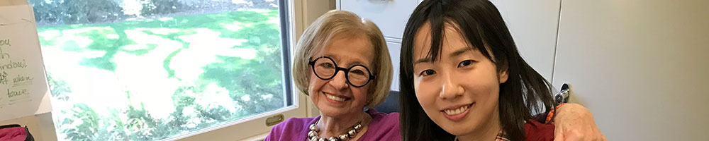 Female Volunteer with female international practicing English.