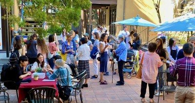 Volunteers and internationals enjoy International Spouse Coffee in the patio.