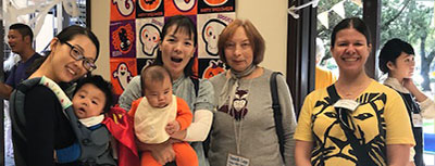 CCIS female volunteer with three female spouses and two babies.