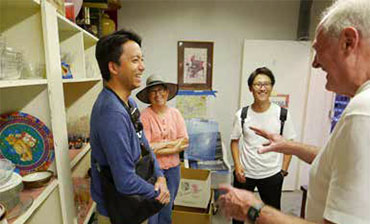 Male volunteer welcoming internationals into the Loan Closet.